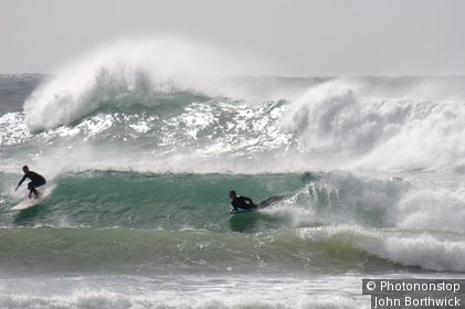 Two surfers, longboarder and bodyboarder, in big swell on North Coast NSW. Crescent Head, New South Wales, Australia