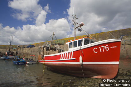 Ireland, Republic of Ireland, Munster, Helvick Head, Red fishing boat, Helvick Head Pier.