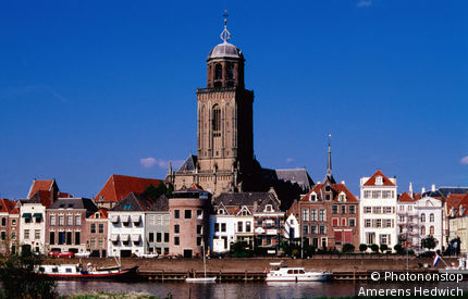 Netherlands, Overijssel, Deventer, Grote or Lebuinuschurch towers above town buildings.